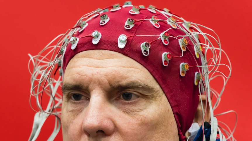 researcher using a Brain-Computer-Interface helmet