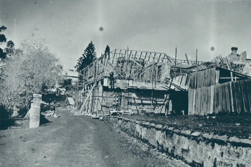 The Law Courts and Commandant's Offices at Port Arthur with scaffolding around it, being rebuilt after a fire.