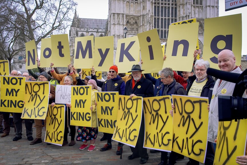A group of protesters holding signs saying 'Not My King'. 