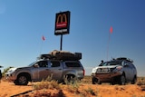 Cars around Simpson Desert McDonald's sign