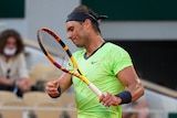 Rafael Nadal hits his racquet in frustration
