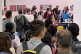 A ine of passengers in Perth Airport waiting to be screened for COVID-19.