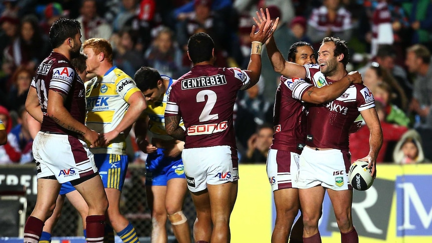 Manly players celebrate a try by Jorge Taufua (#2) during their match with Parramatta.