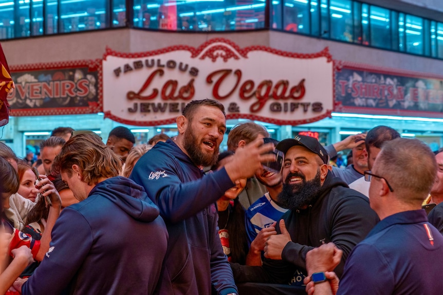 Jared Waerea-Hargreaves takes a selfie with fans in front of a 'fabulous Las Vegas' sign.