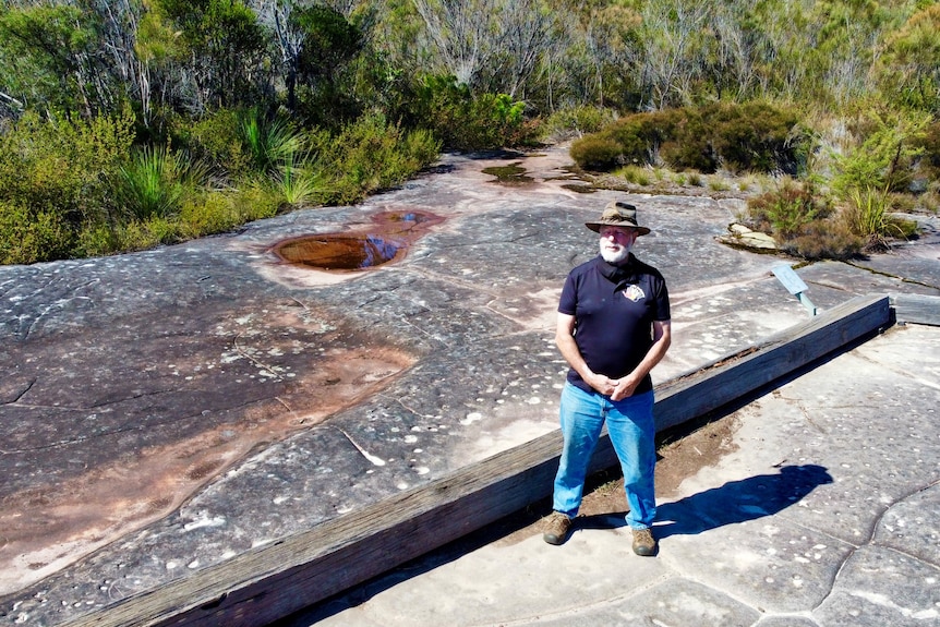 A man in a hat looks at the camera in Ku-rin-gai Chase National Park on the outskirts of Sydney