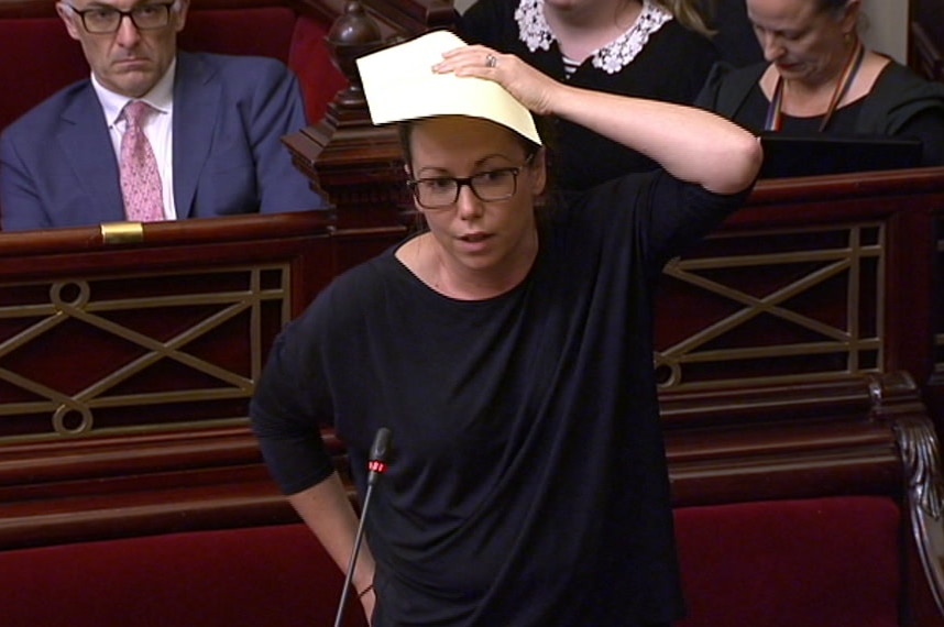 Victorian Labor MP Jaclyn Symes with her hand to her head in parliament.