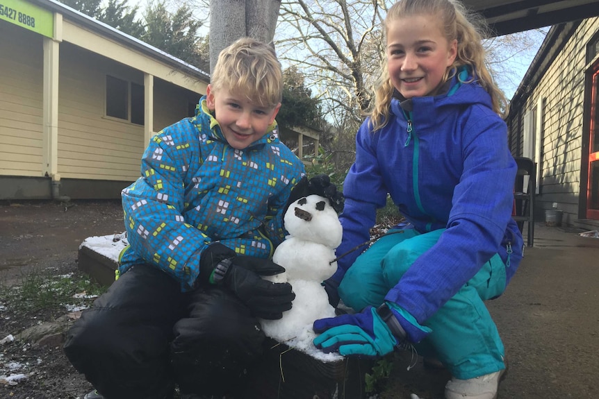 kids with a mini snowman at Macedon, Victoria