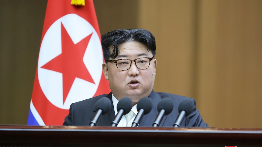 Close up of Kim Jong Un speaking at a podium