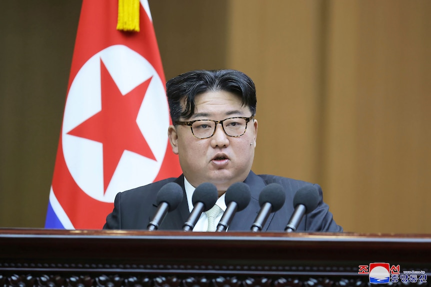 Close up of Kim Jong Un speaking at a podium