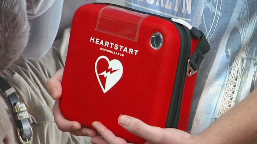 Defibrillator machine in a red case.