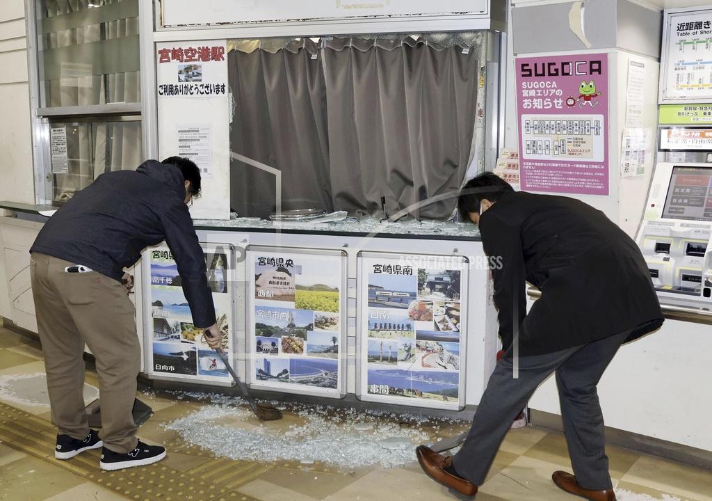 Staff clean up shattered and scattered glass caused by the earthquake at JR Miyazaki Airport Station, in Miyazaki, in southwestern Japan, Monday Jan. 13, 2025. 