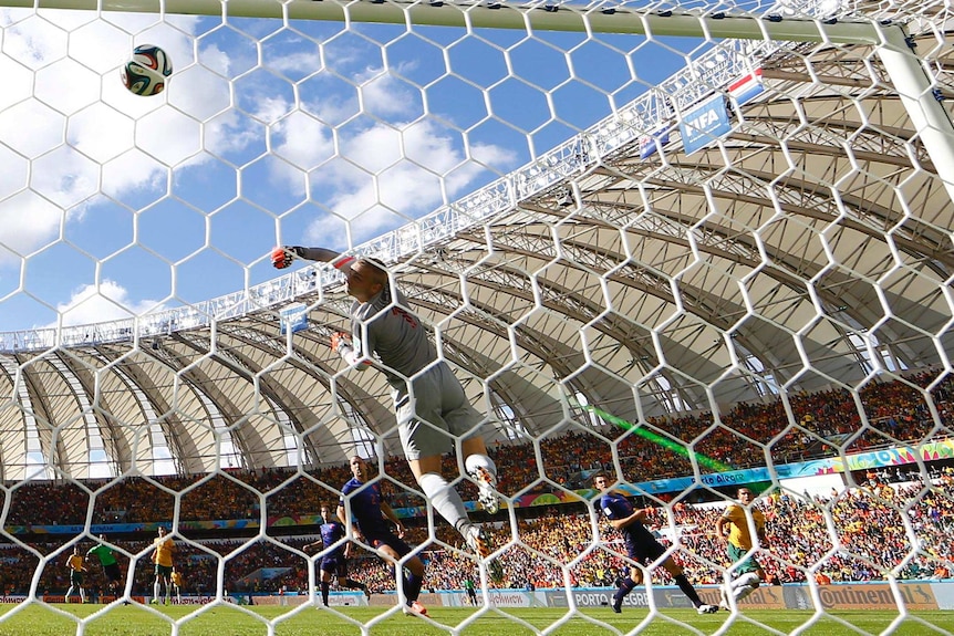 Socceroos forward Tim Cahill scores with a long-range volley against the Netherlands.