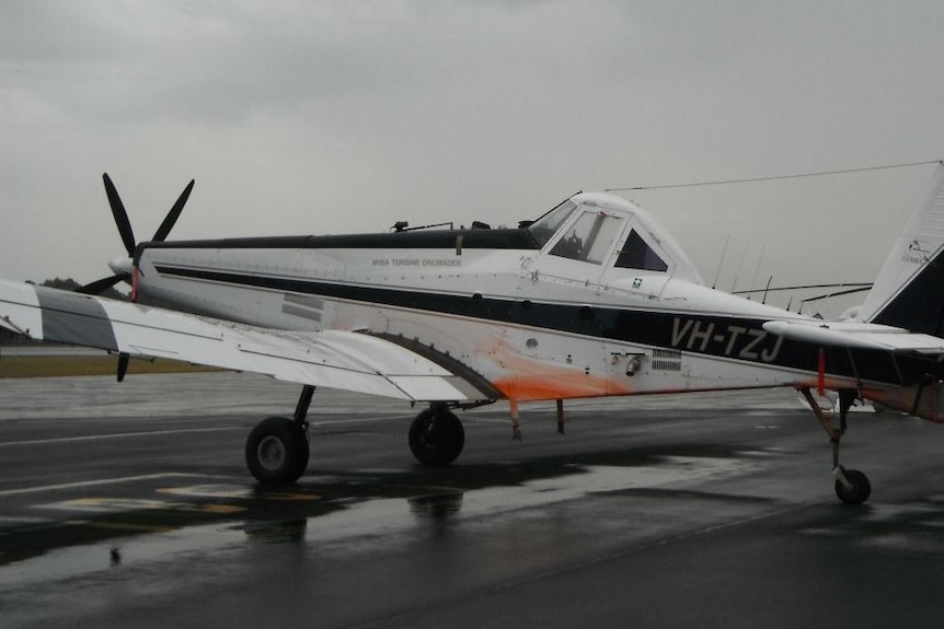 A small plane sitting on the tarmac.