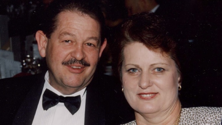 Jim and Lorraine Baff in formal dress smile at the camera, looking happy.