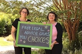 Julie from The Elizabeth Evatt Community Legal Centre and Kim from Legal Aid NSW hold a sign