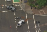 An aerial picture of a road accident with a motorbike lying on the road.