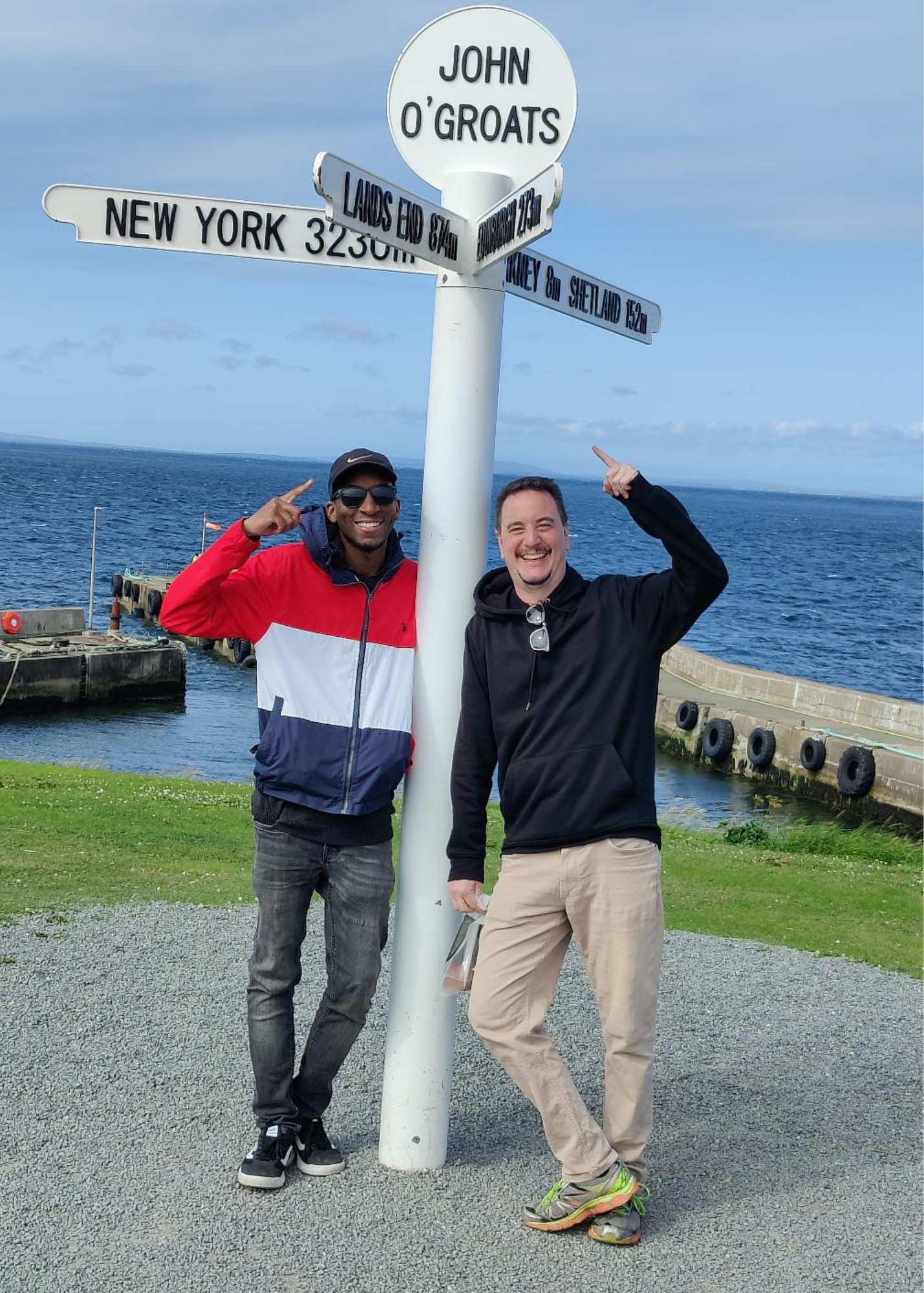 Eric Smith and his partner Warren pose in front of the ocean