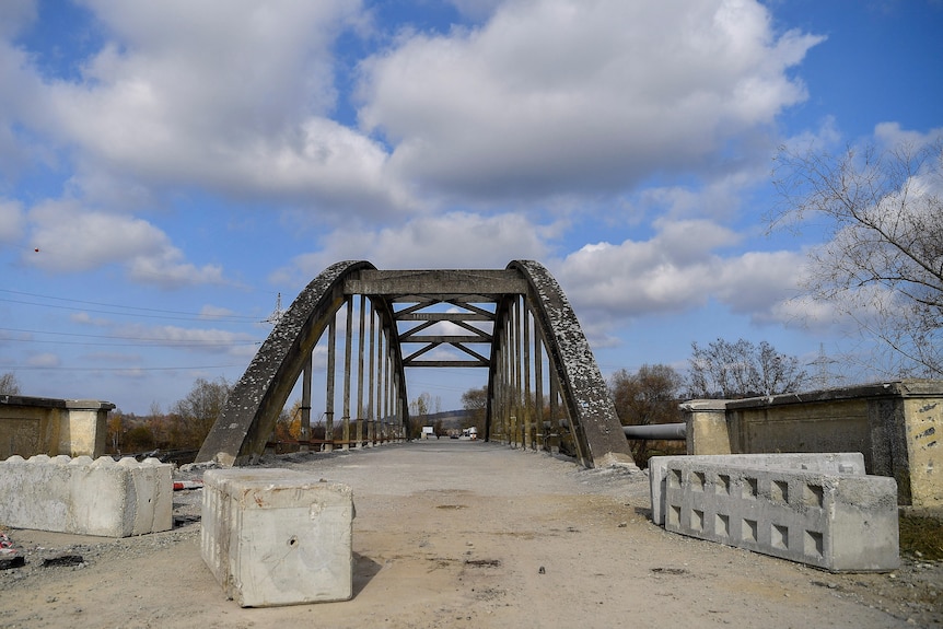 a bridge with large concrete blocks cordoning it off