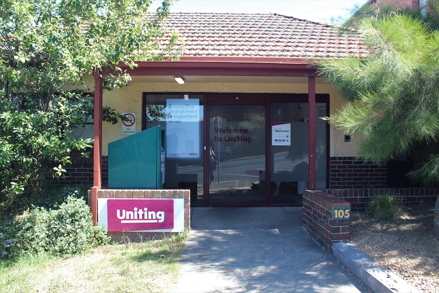 The entry to a building with a sign that says Uniting 