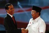 Indonesia's presidential candidate Joko Widodo shakes hands with his opponent Prabowo Subianto