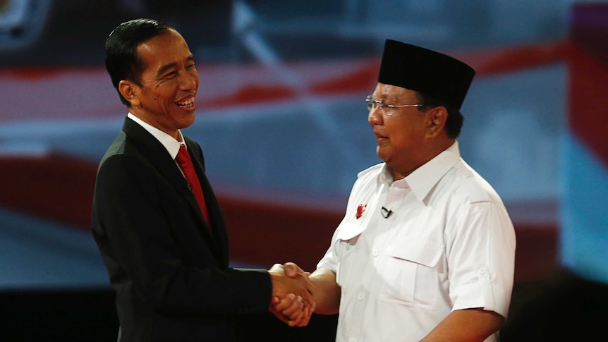 Indonesia's presidential candidate Joko Widodo shakes hands with his opponent Prabowo Subianto