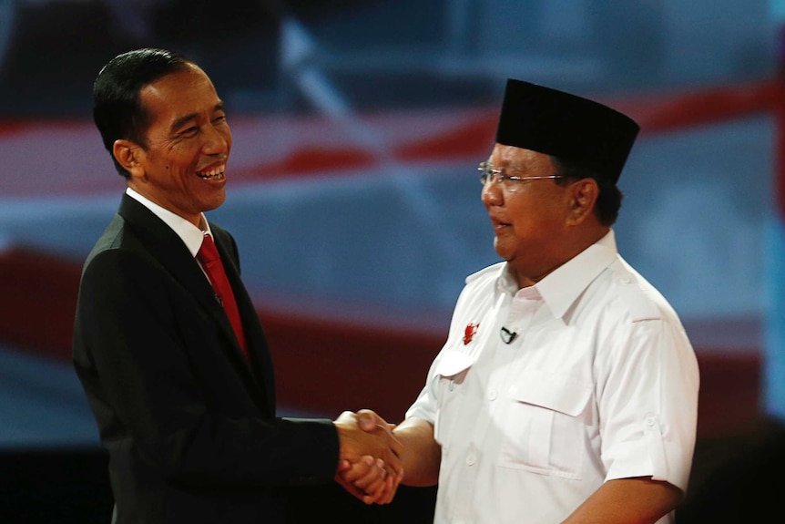 Indonesia's presidential candidate Joko Widodo shakes hands with his opponent Prabowo Subianto