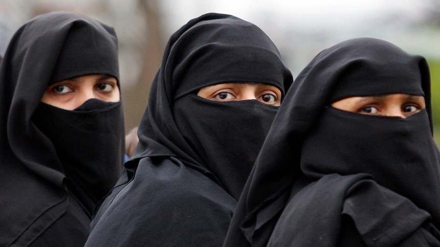 Veiled Muslim women look towards camera in Saudi Arabia