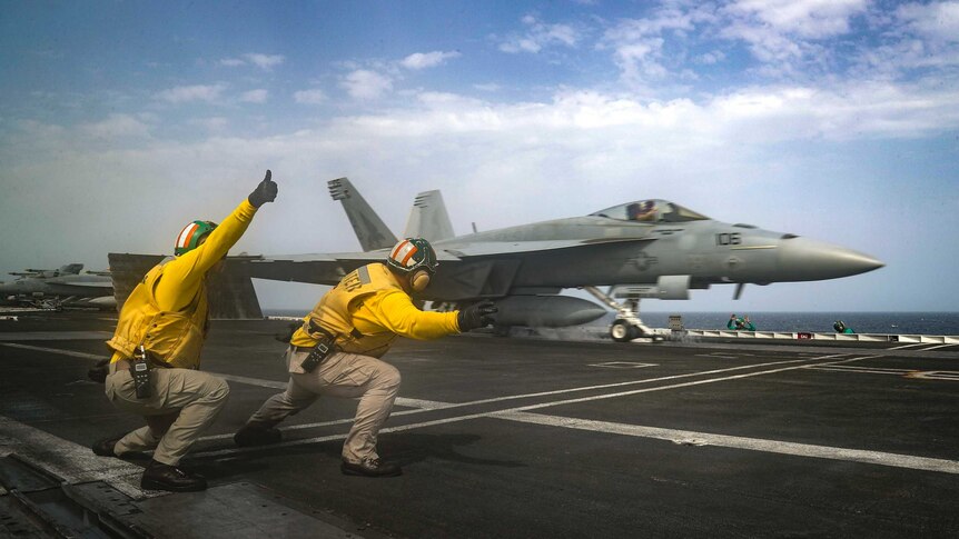 An F-18 Super Hornet is launched from the deck of the USS Abraham Lincoln aircraft carrier in the Arabian Sea