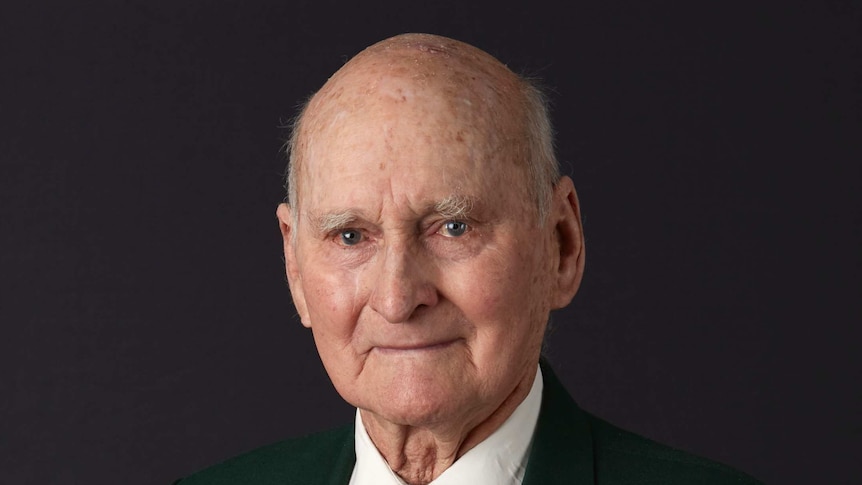 Portrait photo of an elderly man wearing war medals.