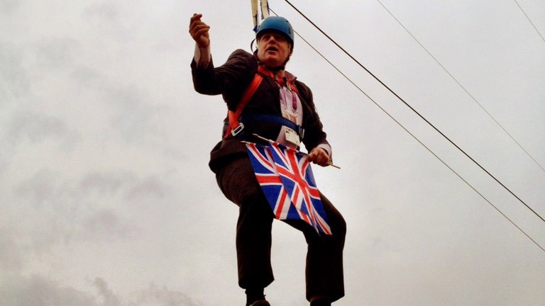 Man in a suit dangling from a zipline