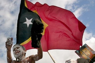 East Timor: A young boy with a painted face joins a protest in Dili.