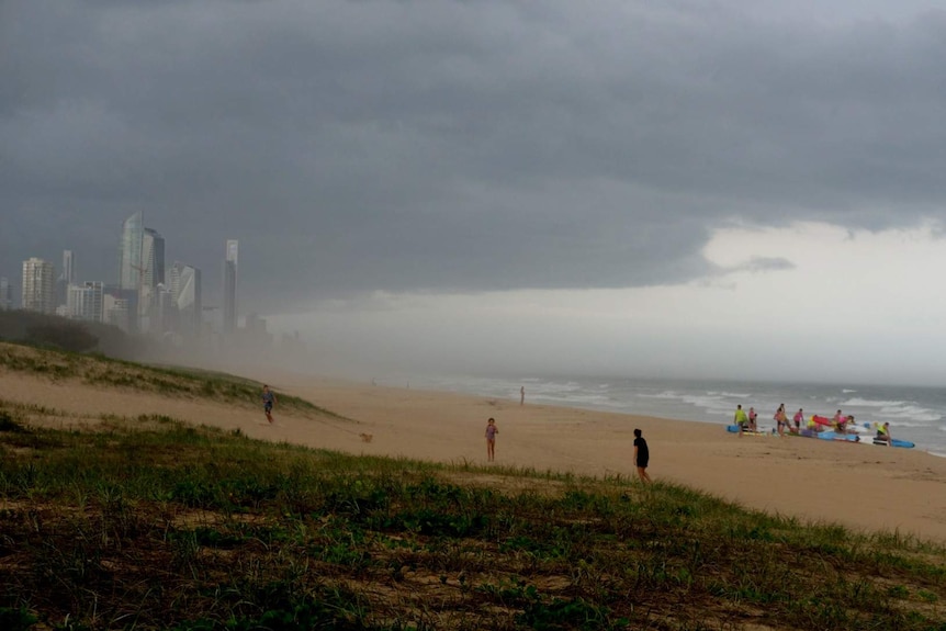 The storms rolled in across Surfers Paradise as beach-goers quickly sought shelter.