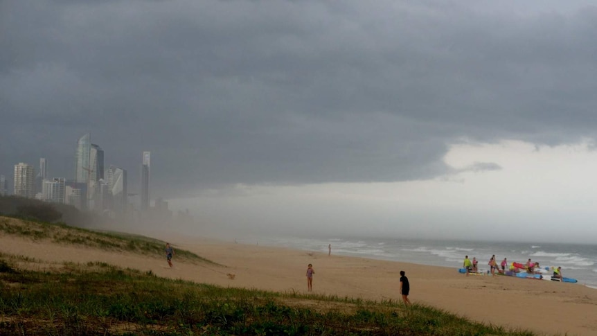 The storms rolled in across Surfers Paradise as beach-goers quickly sought shelter.