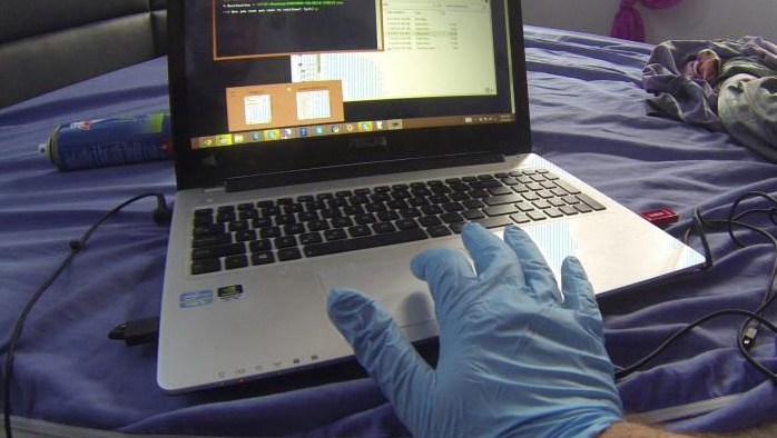 Forensic police officer using laptop