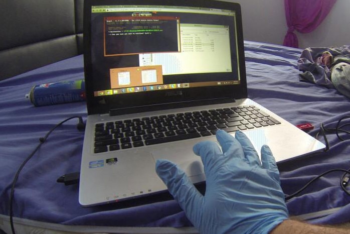 Forensic police officer using laptop