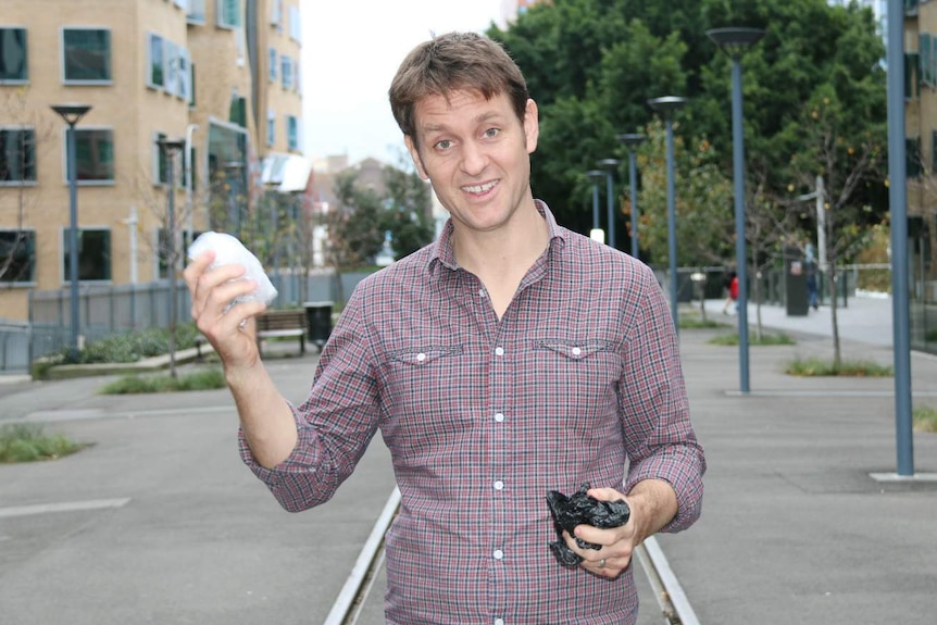 A man holding plastic bags.