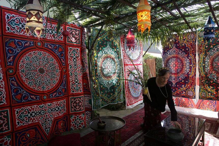 A woman decorates her succah, a traditional Jewish temporary dwelling, installed to mark the harvest festival of sukkot.