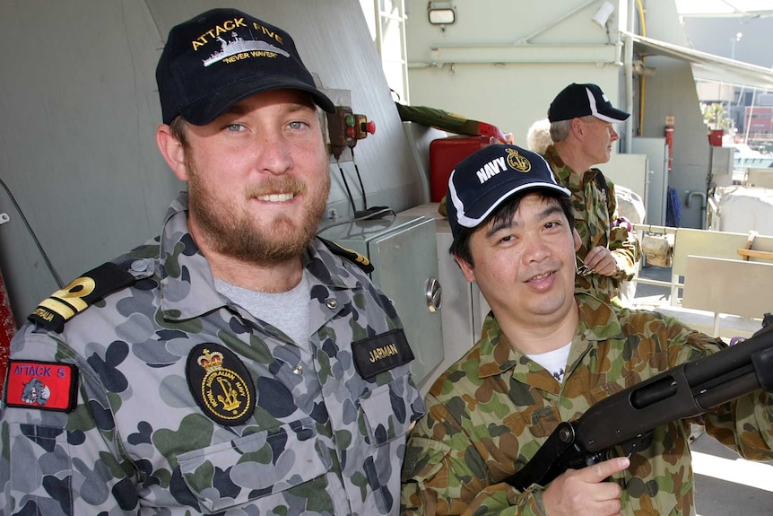 Lieutenant Scott Jarman with a visitor to HMAS Bathurst during Exercise Boss Lift 2012.