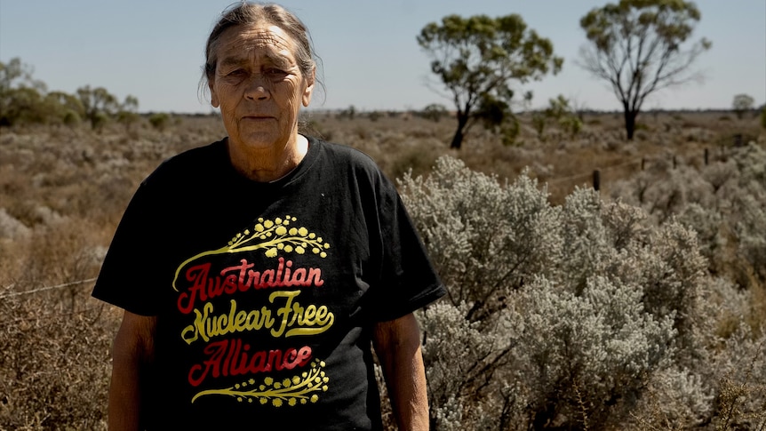 Indigenous woman with a black shirt that reads 'Australian Nuclear Free Alliance'.