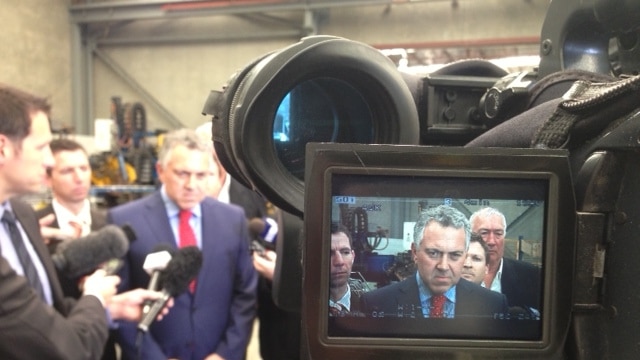 Joe Hockey surrounded by reporters