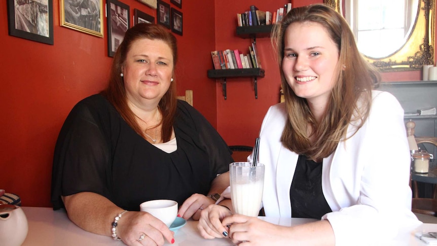 Marijke Phillips (left) has sits with Leatisha Phillips (right) at a table.