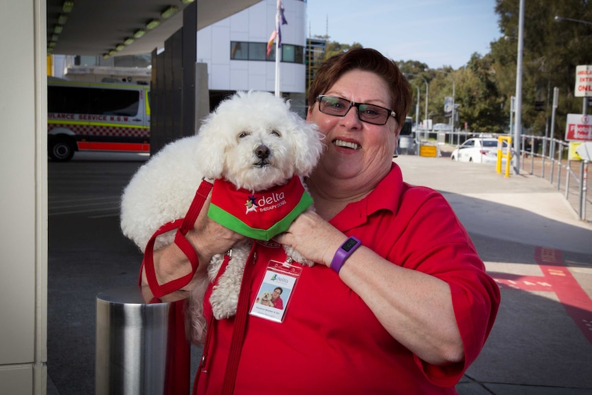 Suzanne Madden with her dog Zach outside the John Hunter Hospital.