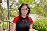 a young woman in glasses with a t-shirt which says doom and gloom