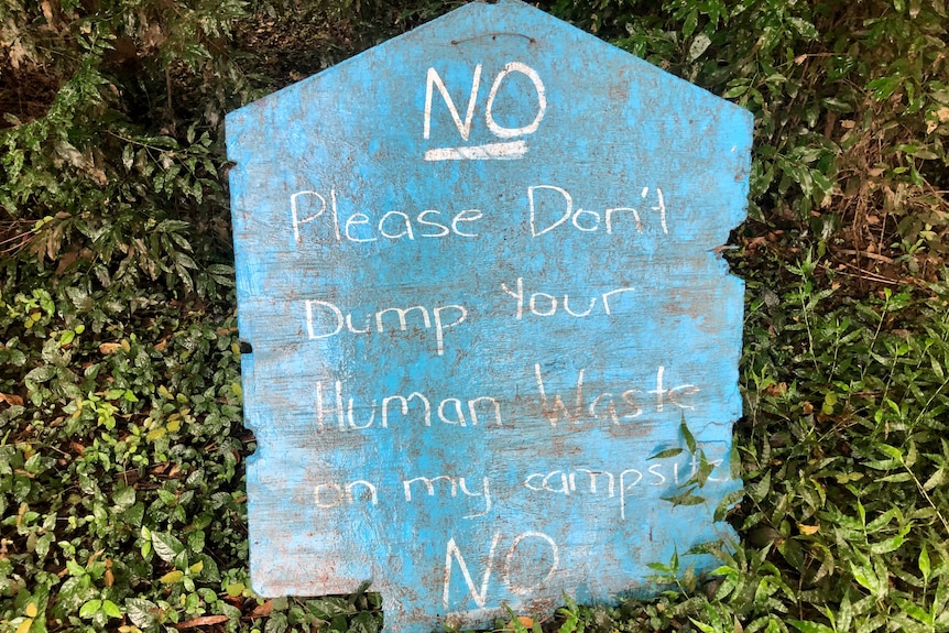 Sign that says 'please don't dump your human waste on my campsite'.