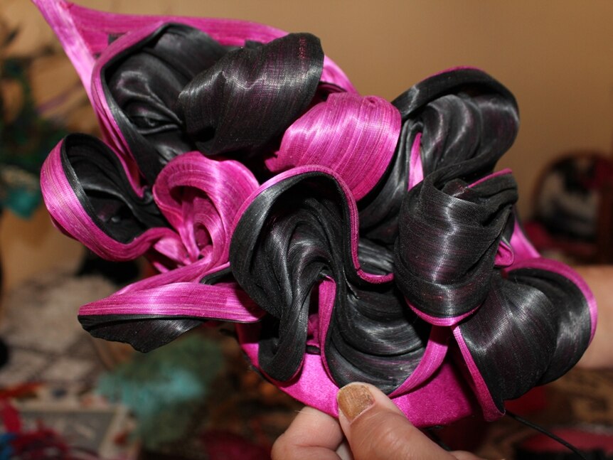 black and pink swirls on top of a hat made from silk and abaca fibre.