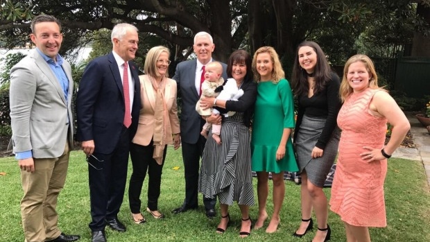 A group of people look at the camera.