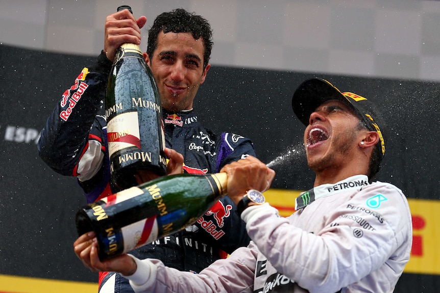 Daniel Ricciardo and Lewis Hamilton celebrate on the podium