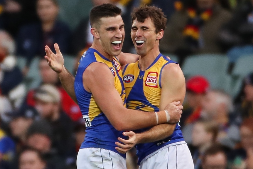 Two West Coast Eagles AFL players embrace after a goal was kicked against Adelaide.