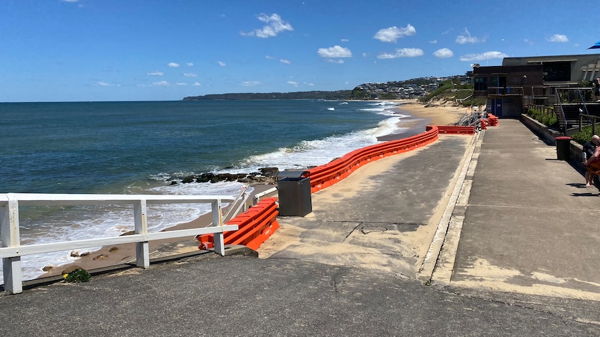 bar beach in newcastle with orange safety barriers blocking access to the water