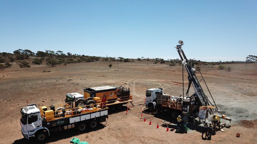 A drone provides an aerial view of a drilling rig working in outback